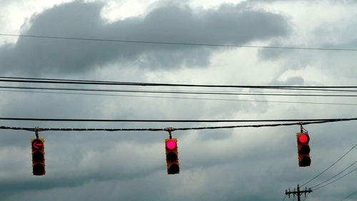 Low angle view of traffic lights against sky