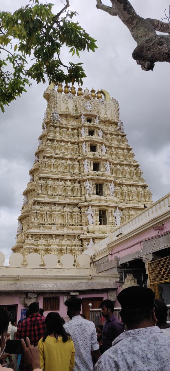 PEOPLE OUTSIDE TEMPLE AGAINST BUILDING