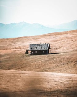 Lifeguard hut on land against sky