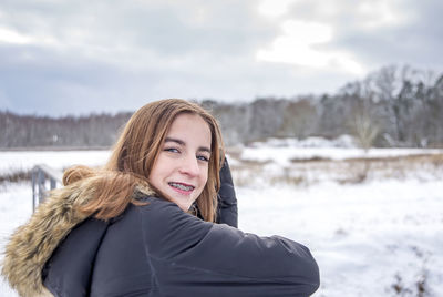 Portrait of smiling woman in snow