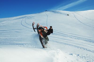 Snowmobile rider playing on deep snow
