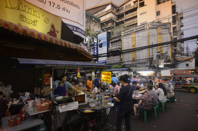 People at street food stall in city