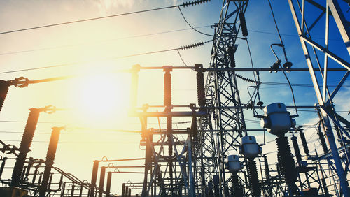 Low angle view of electricity pylon against sky