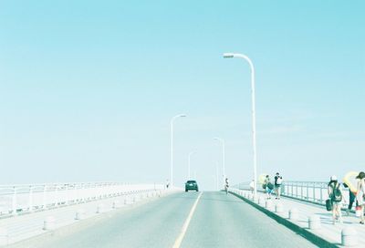 Cars on road against clear sky