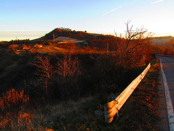 Built structure on field against sky during sunset