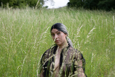 Portrait of teenage girl standing on field