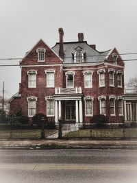 Building by road against sky