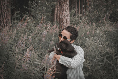 Young woman with dog in forest