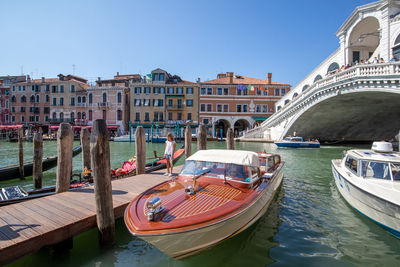 Panoramic view of boats moored in canal