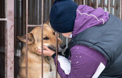 Girl volunteer in the nursery for dogs. shelter for stray dogs.