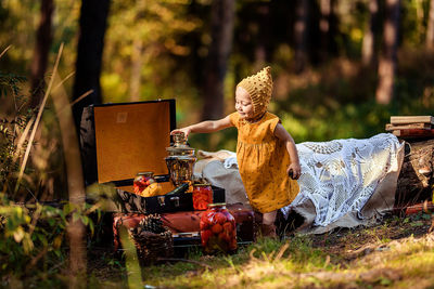 Side view of woman sitting in forest