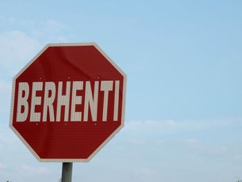 Road sign against sky