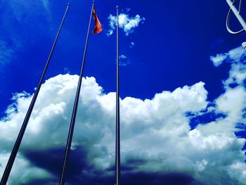 Low angle view of flag against blue sky