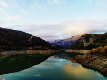 Scenic view of lake and mountains against sky