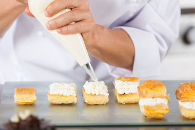 Close-up of chef icing dessert