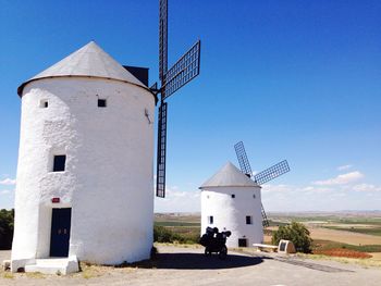 Traditional windmills against sky