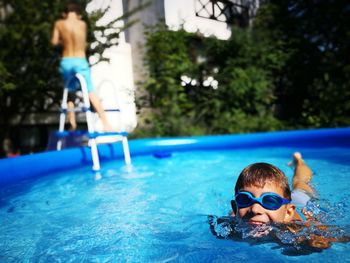 Boy swimming in wading pool