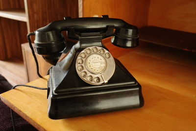 Close-up of telephone booth on table