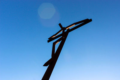Low angle view of traditional windmill against clear blue sky