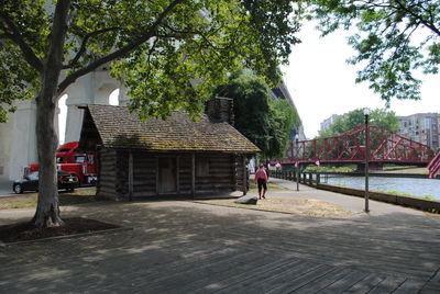 Man walking on built structure against trees