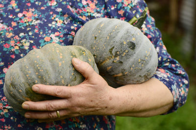 Close-up of hand holding pumpkin