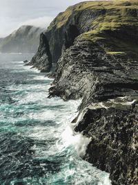 Scenic view of sea by rock formations