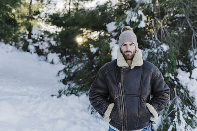 Young man standing in snow