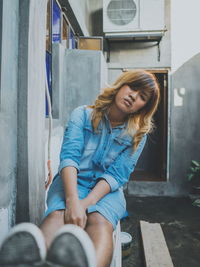 Beautiful young woman in front of building