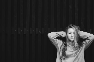 Woman standing against the wall