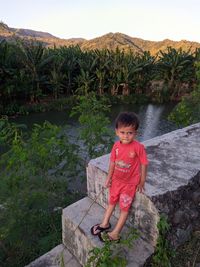 Portrait of boy sitting on mountain