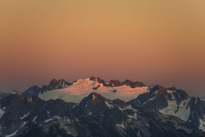 Alpenglow on glacier and mountain peaks, washington state, usa.