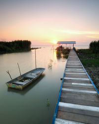 View of calm sea against romantic sky at sunset