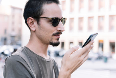 Portrait of young man using mobile phone