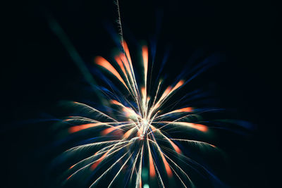 Low angle view of firework display against sky at night