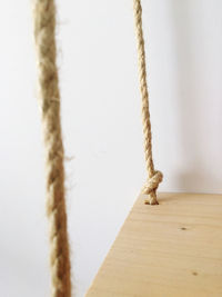 Close-up of rope against wall