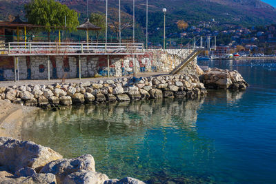 Scenic view of sea by rocks against sky