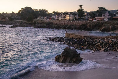 Rocks by sea against sky