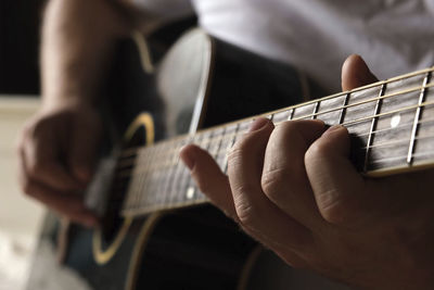 Cropped hand playing guitar