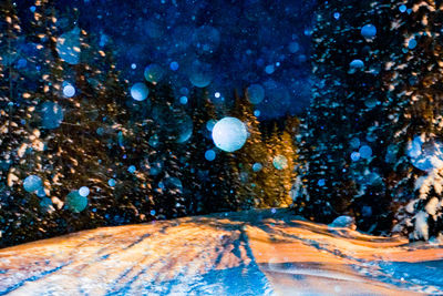 Snow covered mountain against sky at night