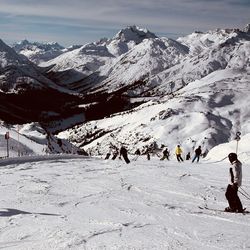 People on snowcapped mountains during winter