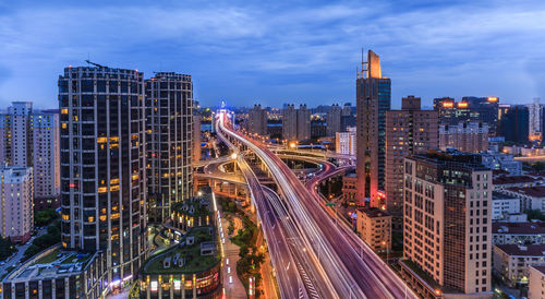 Illuminated cityscape against sky