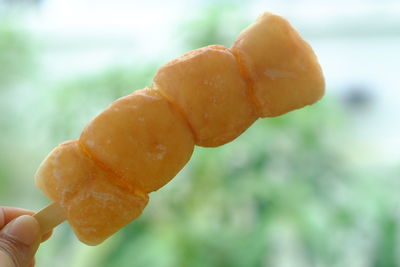 Close-up of hand holding ice cream