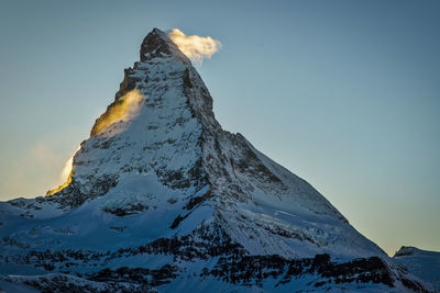 Scenic view of snowcapped mountain against sky