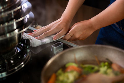 Midsection of man preparing food