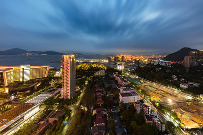 High angle view of illuminated buildings against sky at night