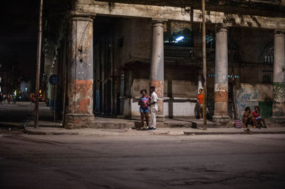 Man standing by abandoned building