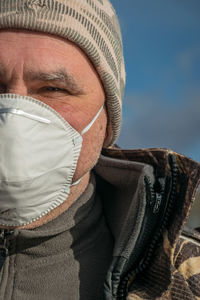 Low angle view of man wearing mask against sky