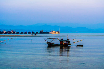 Fishing boat in sea against sky