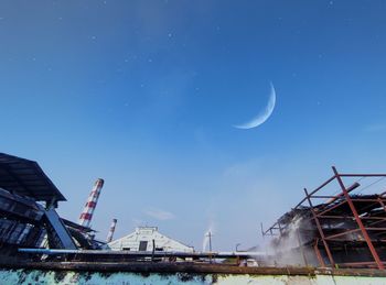 Low angle view of crane against sky at night