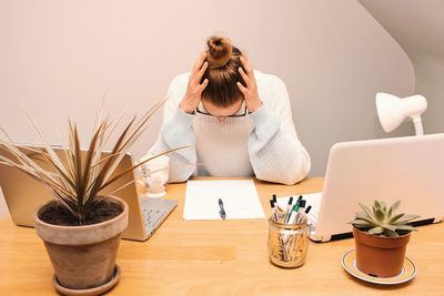 Caucasian brunette young woman working from her home office